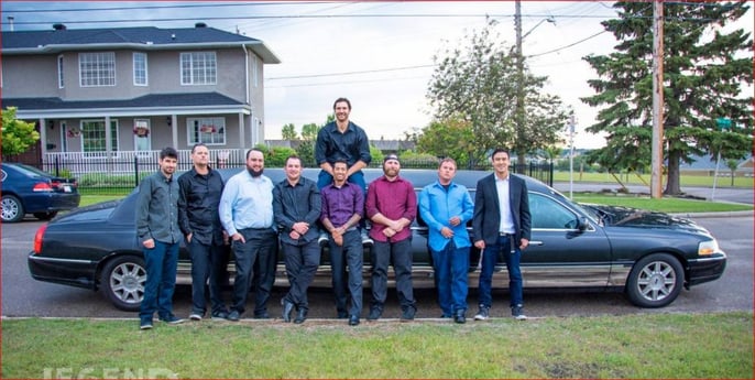 Group of guys standing with black Lincoln Stretch Limousine