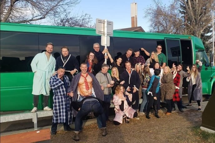 PJ party photo in front of green Godzilla party bus