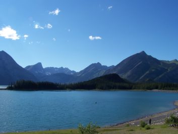 Photograph of lake with mountains and blue sky in background in Banff National Park