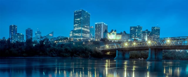 City of Edmonton skyline at dusk with view of river looking into downtown